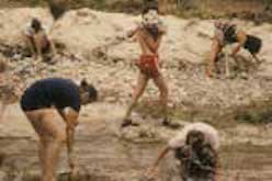 Five people prepping the creekbed
