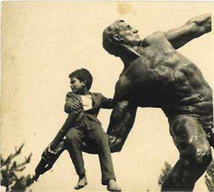Child sitting on a large figurative sculpture