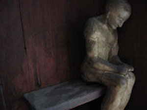 Detail of Man in Dwelling wall sculpture