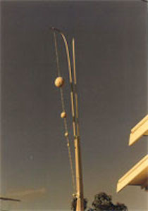 Vertical sculpture with three spheres on string