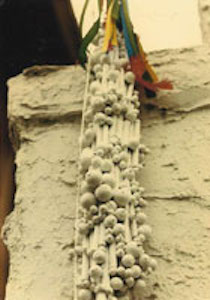 Closeup of vertical sculpture with beading
