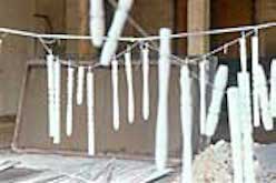 Found objects pianted white and hanging to dry