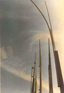 Row of vertical sculptures arching in the wind