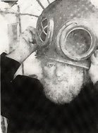 Slobodan holding a diver's helmet over his head