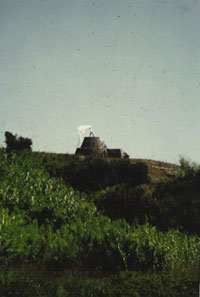 Slobodan waving large silk banner on top of a trulo