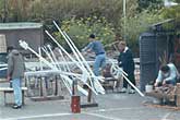 Distance shot of people making vertical sculpture