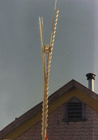 Vertical sculpture with roof peak in background